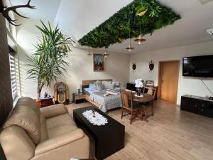 a living room with a couch and a table at Villa Louis Hirsch in Gera