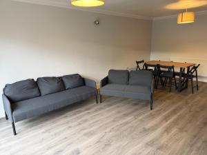 a living room with a couch and a table at Spacious Glasgow Group Stay in Glasgow +6 photos