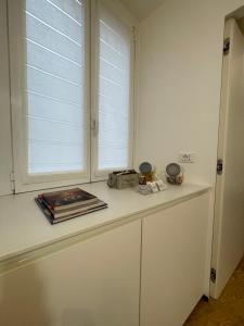 a kitchen counter with a window and a book at Torino48 Studio Apartment in Milan +5 photos