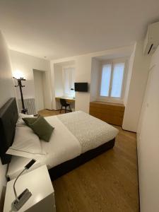 a bedroom with a bed and a desk in it at Torino48 Studio Apartment in Milan