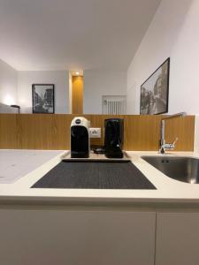 a kitchen with a sink and a toaster on a counter at Torino48 Studio Apartment in Milan