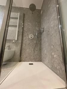 a bathroom with a shower with a sink and a toilet at Torino48 Studio Apartment in Milan