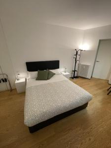 a bedroom with a bed and two night stands at Torino48 Studio Apartment in Milan