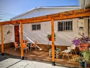 a wooden pergola with a table and chairs on a deck at MatSofy_Apartamento in Santiago