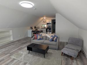 a living room with a couch and a chair at Apartment 1 in Rockingham