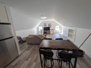 a kitchen and living room with a table and chairs at Apartment 1 in Rockingham +2 photos
