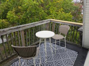 a white table and two chairs on a balcony at Apartment 1 in Rockingham