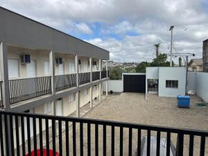 a balcony of a building with a parking lot at Hotel dallas in Telêmaco Borba