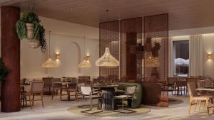 a restaurant with tables and chairs and pendant lights at The Lince Ecorkhotel Évora in Évora