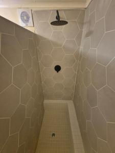 a small bathroom with a shower with a drain at Vida Lenta in Springbok +34 photos
