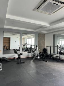 a gym with several treadmills and ellipticals and mirrors at Beachfront 2BR Luxury Living Walk Everywhere in Cartagena de Indias