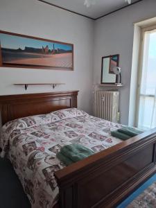 a bedroom with a bed with a quilt on it at Rifugio Delia in Torre Pellice
