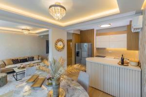 a kitchen and a living room with a table at Vujanović Apartments in Sveti Stefan