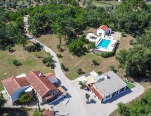 an aerial view of a house with a swimming pool at Quinta Cabecinha in Penela