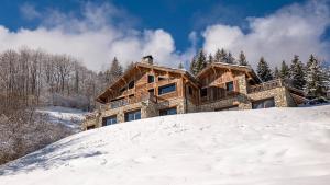 a house on top of a snow covered hill at MGM Hôtels & Résidences - Le Chalet Apsara in Méribel
