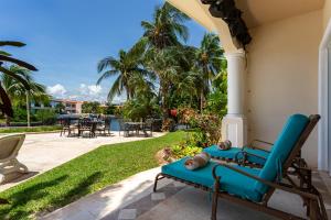 a patio with a blue couch on a house at Aventuras Club Laguna in Puerto Aventuras
