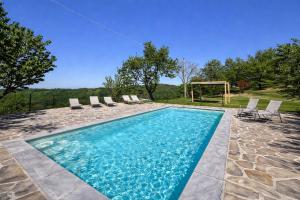 a swimming pool with chairs and a gazebo at LA CASA DI TALIN - Camere e appartamenti - Accoglienza adults only in Serravalle delle Langhe