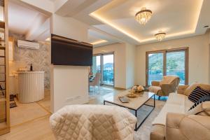 a living room with a couch and a table at Vujanović Apartments in Sveti Stefan