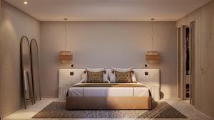 a bedroom with a large white bed with two chairs at The Lince Ecorkhotel Évora in Évora +71 photos