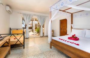 a bedroom with a bed and a table at Seashore Beach hotel and Bungalow in Kumba Urembo +113 photos