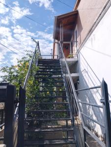 a staircase leading up to a building with flowers at Alvear Departamento B in Venado Tuerto