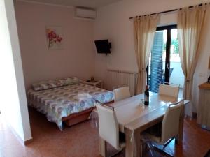 a bedroom with a bed and a table with chairs at Apartment Vesna in Veleniki