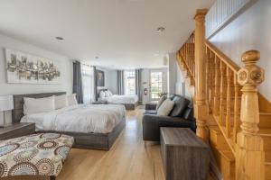 a bedroom with a bed and a stair case at Le Gaspesiana in Sainte-Flavie +70 photos