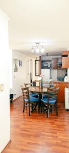 a kitchen and dining room with a table and chairs at Departamentos Home Bulnes in Santiago