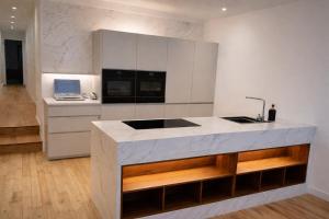 a white kitchen with a sink and a counter at Burgschelde 61 in Oudenaarde