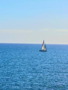 a sail boat in the middle of the ocean at Perla Sul Mare in Gallipoli +4 photos