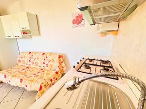 a kitchen with a sink and a stove in a room at Perla Sul Mare in Gallipoli
