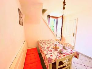 a dining room with a table and a staircase at Perla Sul Mare in Gallipoli