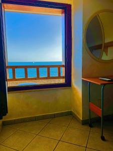 a room with a window with a view of the ocean at Perla Sul Mare in Gallipoli