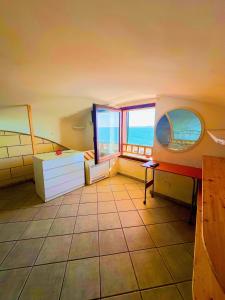 a bathroom with a window and a view of the ocean at Perla Sul Mare in Gallipoli