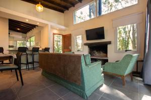 a living room with a couch and a fireplace at Casa Frida vivir sin prisa in Mar de las Pampas