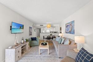 a living room with a couch and a table at Wow! Oceanview 3 bedroom condo! Pool & private balcony in Myrtle Beach