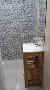a bathroom with a sink and a mirror at Dpto amueblado con cochera descubierta in Río Tercero