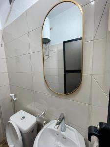 a bathroom with a mirror and a toilet and a sink at AmkGroup in Dakar