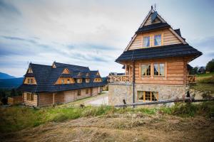 コシチェリスコにあるSmrekowy Dworekの丘の上に座る大きな木造家屋