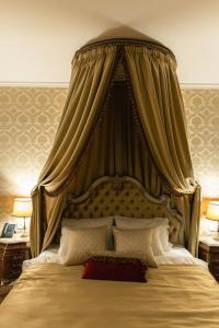 a bedroom with a large bed with a canopy at Winery La Gora in Irig
