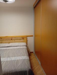 a small bedroom with a bed and a closet at Casa del Abuelo in Tabernas