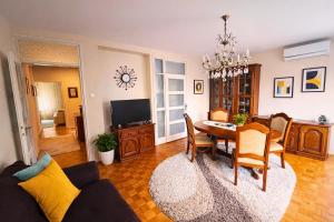 a living room with a table and a dining room at Central Park Apartment in Čačak