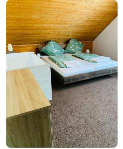 a bedroom with a bed and a wooden ceiling at 3 Zimmer modern Wohnung mit Netflix und küche in Celle