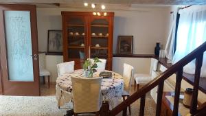 a dining room with a table with chairs and a cabinet at FAVIEROS-The secret Garden in Mesochórion