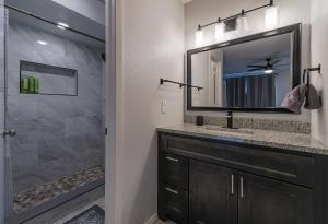 a bathroom with a sink and a mirror at Modern 4 Bedroom home with large, fenced backyard, Pet friendly - 20 mins to DFW Airport in Flower Mound +33 photos