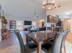 a kitchen and living room with a table and chairs at Modern 4 Bedroom home with large, fenced backyard, Pet friendly - 20 mins to DFW Airport in Flower Mound