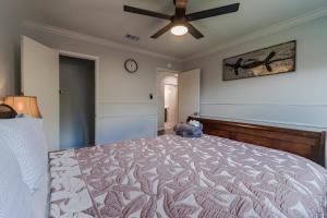 a bedroom with a large bed with a ceiling fan at Modern 4 Bedroom home with large, fenced backyard, Pet friendly - 20 mins to DFW Airport in Flower Mound