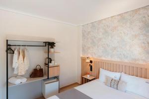 a bedroom with a bed and a wall at Aqua Beachfront Elegant Hotel in Olympic Beach