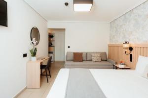 a hotel room with a bed and a couch at Aqua Beachfront Elegant Hotel in Olympic Beach +28 photos