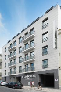 a large white building with people walking in front of it at Fenicius Charme Hotel in Lisbon